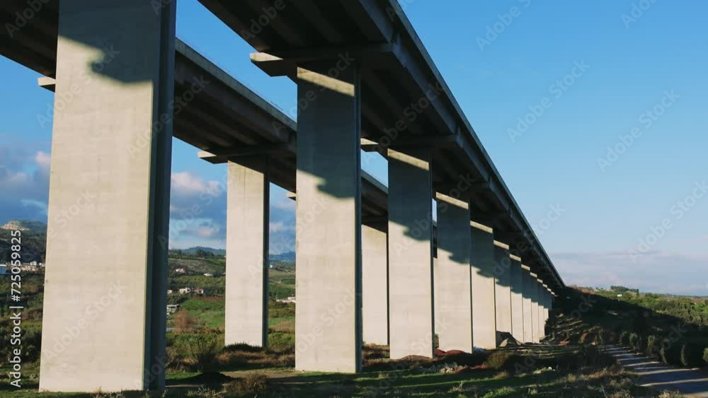 Drone view of concrete mountain expressway viaduct. Automobile, viaduct traffic flows smoothly. Scenic automobile, viaduct amidst nature. Aerial shot captures automobile, viaduct's engineering Drone view of concrete mountain expressway viaduct. Automobile, viaduct traffic flows smoothly. Scenic automobile, viaduct amidst nature. Aerial shot captures automobile, viaduct's engineering