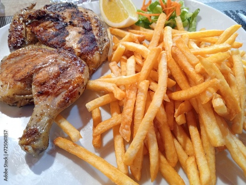 Obraz na płótnie dish with half a grilled chicken and french fries w salonie