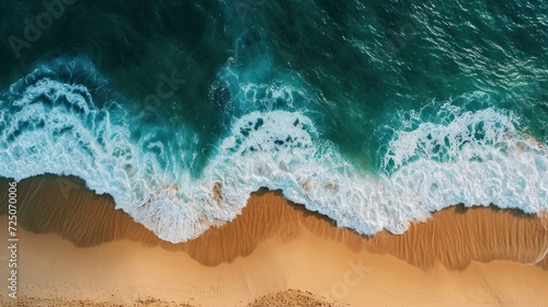  a bird's eye view of a beach with waves crashing on the sand and the ocean in the background.
