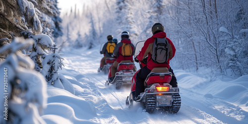 A group of people riding snowmobiles at a nordic coutry and make an outdoor adventure between the snowy woods