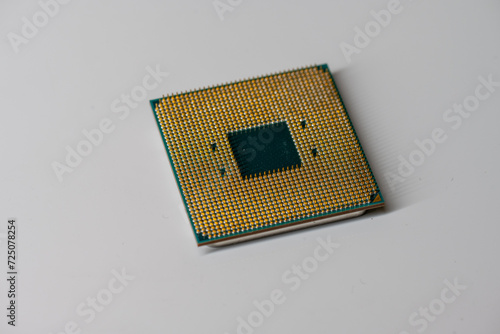Pins of a AMD Ryzen 5 1600 CPU on white table. photo