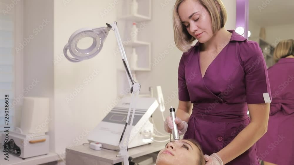 Beautician at work in the process of performing a cosmetic procedure in a beauty clinic. Beautician at work in the process of performing a cosmetic procedure in a beauty clinic.