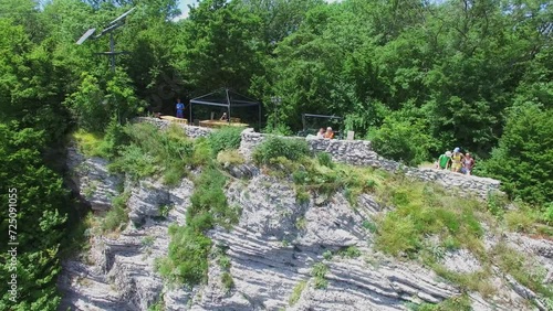 People get rest near solar panel among plants on Orlinye cliffs  photo