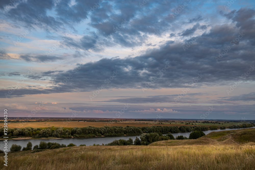 clouds over the river, evening over the river, view from the hill to the endless expanses of fields