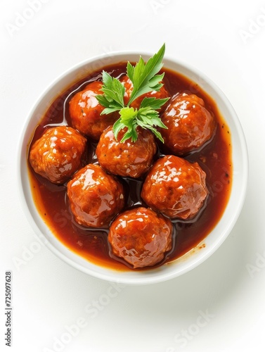 a bowl of meatballs with sauce and parsley