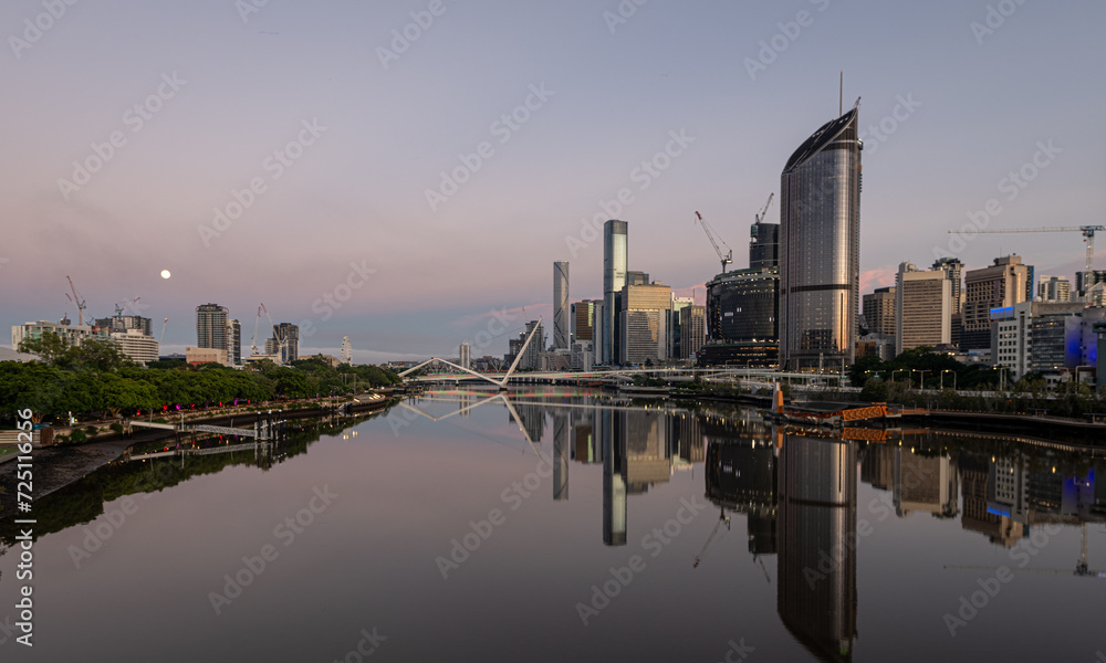 View of  Brisbane downtown, and South Bank District connected by Pedestrian Bridge at daybreak 
