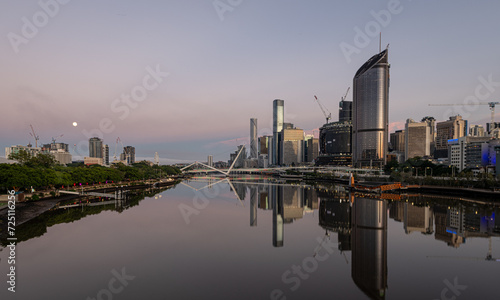 View of  Brisbane downtown, and South Bank District connected by Pedestrian Bridge at daybreak  © jon