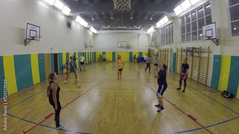 People in circle throw and receive balls on volleyball train in school gym. People in circle throw and receive balls on volleyball train in school gym.