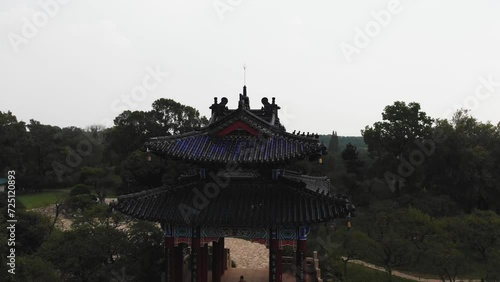 Panoramic view of woods in China with an old pagoda. Top down view of chinese pagoda temple in Nanjing, China. Drone video over Purple Zijin mountain. Travel video in asia inside china.