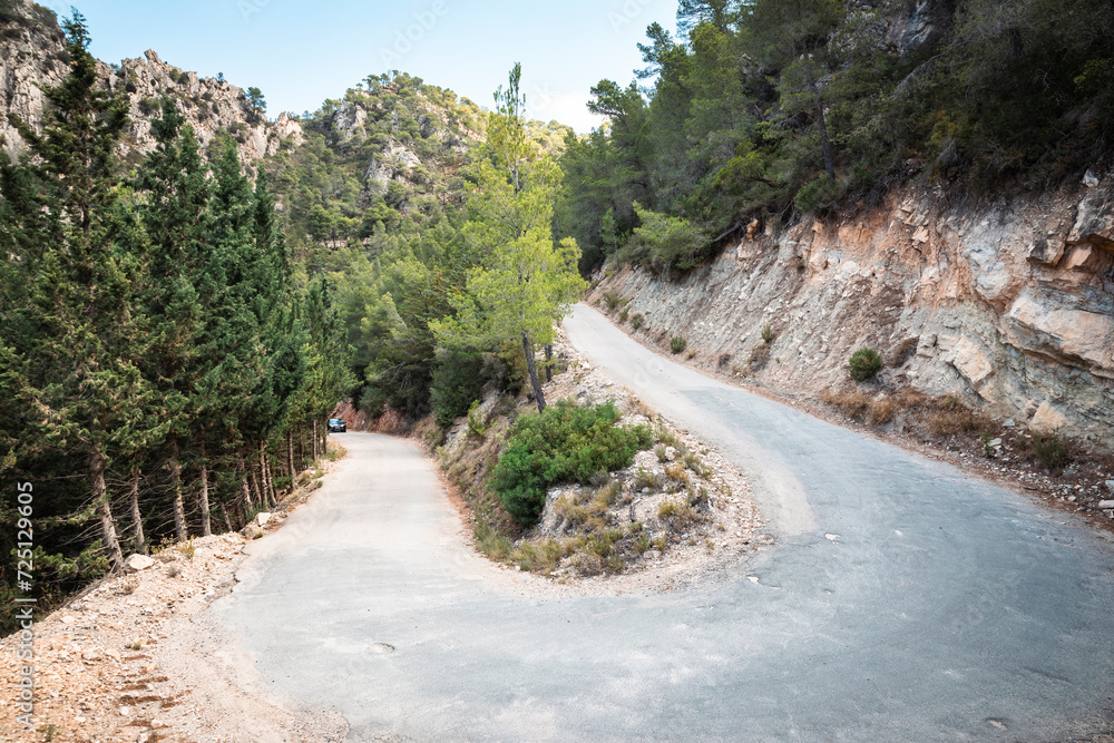 a mountain road with a 360 degree curve next to La Fontcalda (hot spring), area of Pandols-Cavalls mountain range, Prat de Comte, Tarragona, Catalonia, Spain