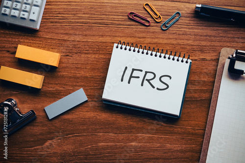 There is notebook with the word IFRS. It is an abbreviation for International Financial Reporting Standard as eye-catching image. © hogehoge511