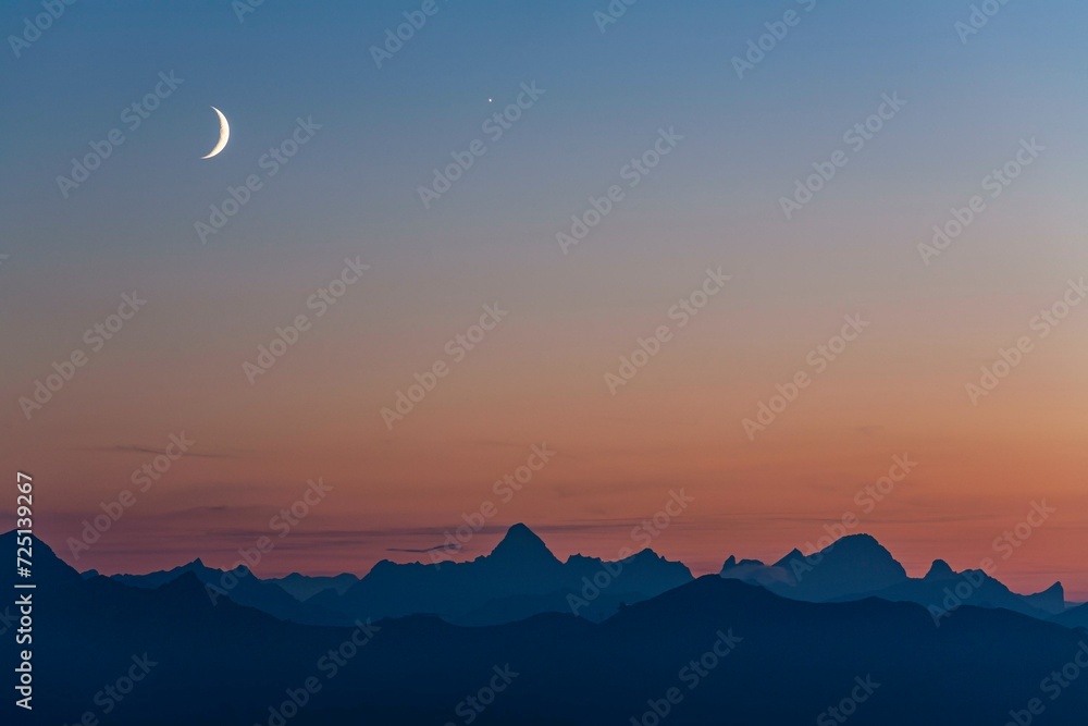 Mountain range at dusk with crescent moon, summer, Allgaeu Alps, Allgaeu, Germany, Europe Mountain range at dusk with crescent moon, summer, Allgaeu Alps, Allgaeu, Germany, Europe