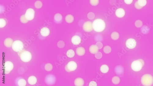 Defocused bokeh particles lights on pink background 4K loop