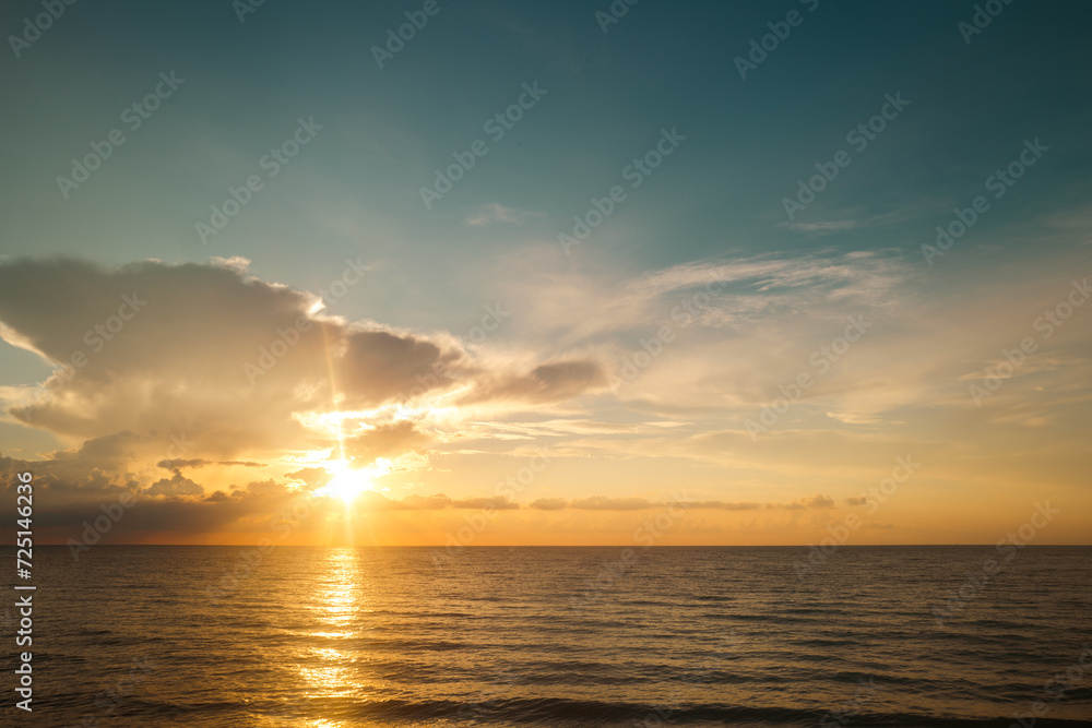 Cloudy sky on sea sunset, sunrise on ocean beach. Sunset landscape in the sky after sunset. Sunrise with clouds of different colors against the sky and sea.