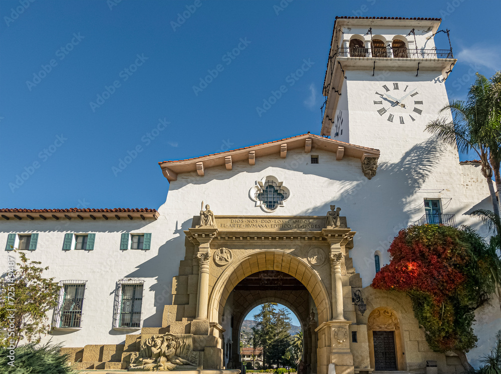 Santa Barbara, CA, USA - November 30, 2023: Santa Barbara County Courthouse monumental great arch set in white stone and tower against blue sky
