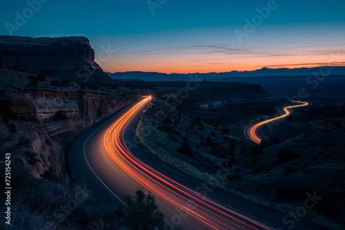 Long exposures of cars streaking down the highway through canyon country during twilight