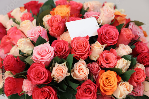 Bouquet of beautiful roses with blank card  closeup
