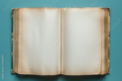 Faded journal with blank pages isolated on a solid blue background, copy space