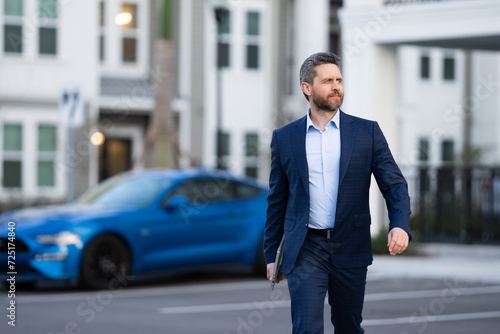 Wallpaper Mural Businessman leaving office. Businessman walking home from work. Businessman working late. Businessman after success office work. End of business day. Successful business man in business suit outdoor. Torontodigital.ca