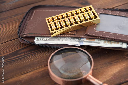 Magnifying glass and gold beads on the wallet