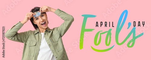 Banner for April Fools' Day with funny young woman on pink background