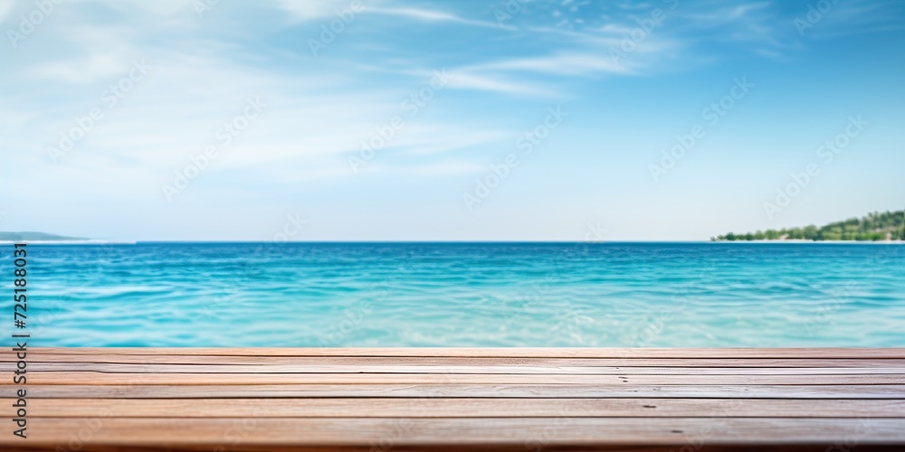 Blurred summer blue sea and sky background with wooden table top.