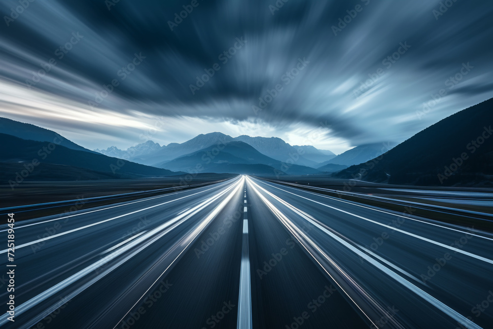 Obraz premium A blurred image of a highway with mountains in the background.