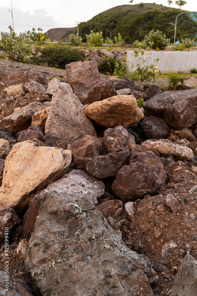 Detailed view of a pile of large rocks removed for paving a road under construction