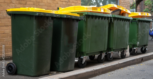 Fotografie Heavy commercial recycle rubbish bins on street kerbside