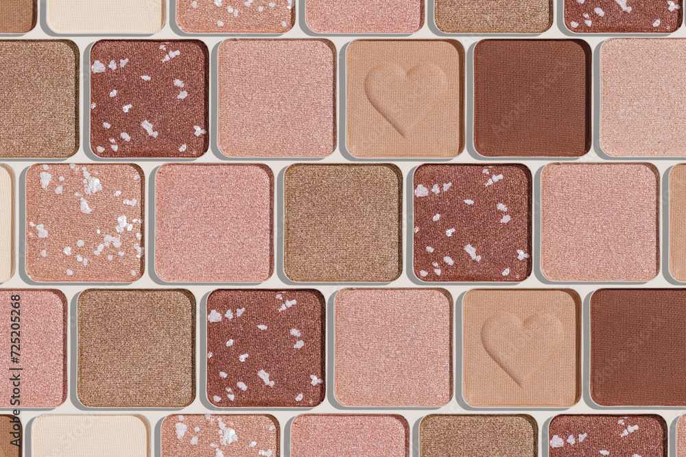Fototapeta premium Minimal pattern of eye shadow beige tones swatches, monochrome photo background, eyeshadow with heart imprint, shiny natural shades powder makeup, square shape metal pack, beauty cosmetic texture