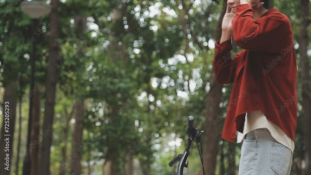 Man enjoying music using earphones while commuting to office on a bicycle. Businessman biking to office while listening to music. Man enjoying music using earphones while commuting to office on a bicycle. Businessman biking to office while listening to music.