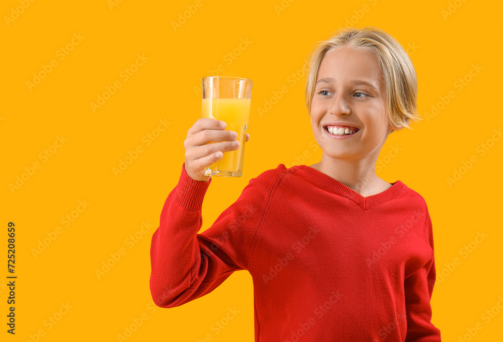 Little boy with glass of orange juice on color background Little boy with glass of orange juice on color background