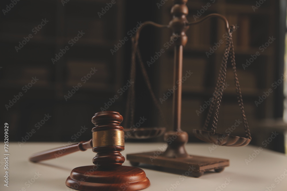 image of judge's hammer, scales lady of justice, law book, laptop computer and contract documents with pen concept of law and justice. image of judge's hammer, scales lady of justice, law book, laptop computer and contract documents with pen concept of law and justice.