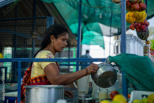A woman from India sells juice she makes.