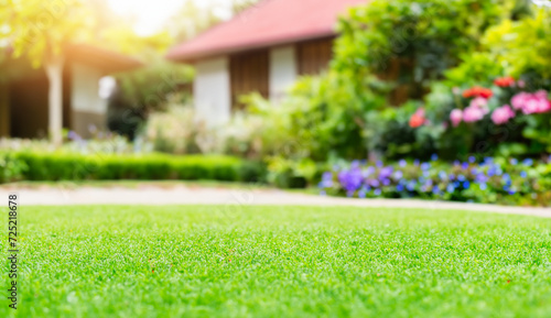 Vibrant Garden Landscape with Lush Green Grass, Colorful Flowers, and Beautiful Trees under a Blue Sky on a Sunny Summer Day