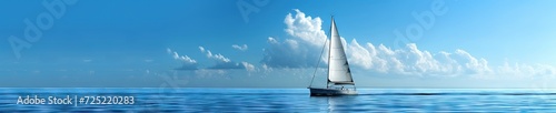 Sailboat sailing on the blue ocean in blue skies