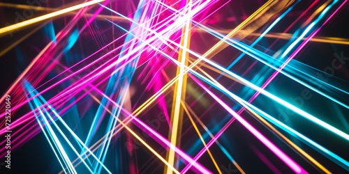 Intersecting light beams, with an array of bright, colored lines crossing over a dark background