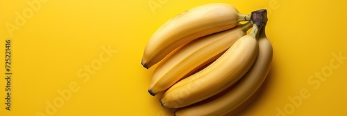 yellow bananas on solid background with copy space photo
