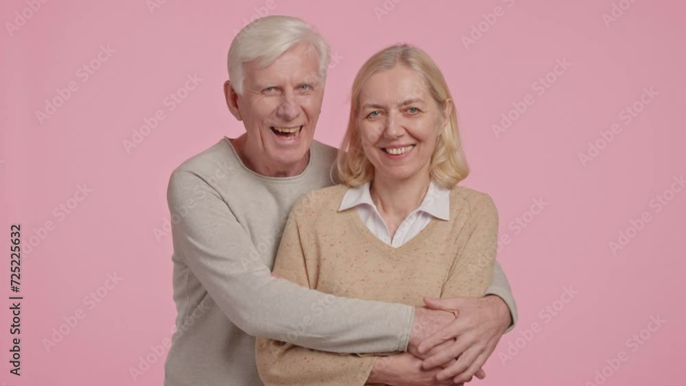 happy adult married couple posing looking at the camera happy adult married couple posing looking at the camera