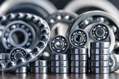 Metal silver radial ball bearings close-up for mechanical engineering, machine tools and equipment, neatly arranged with a ladder up and in a row similar to a diagram against