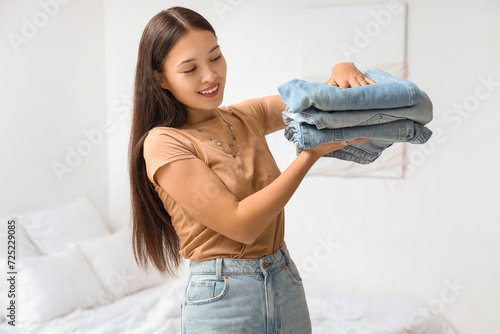 Smiling young asian woman h...