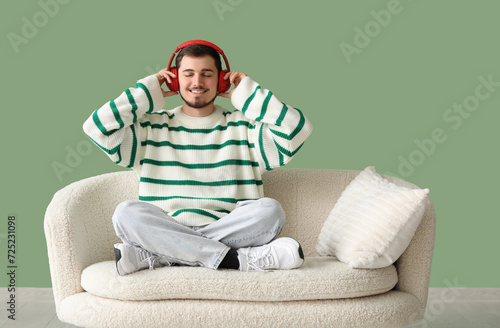 Handsome young man listenin...