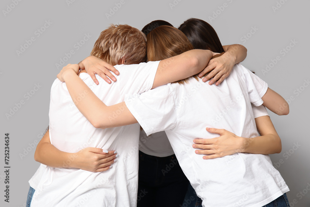 Portrait of hugging women on grey background. Women history month Portrait of hugging women on grey background. Women history month