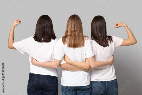Hugging women on grey backg...