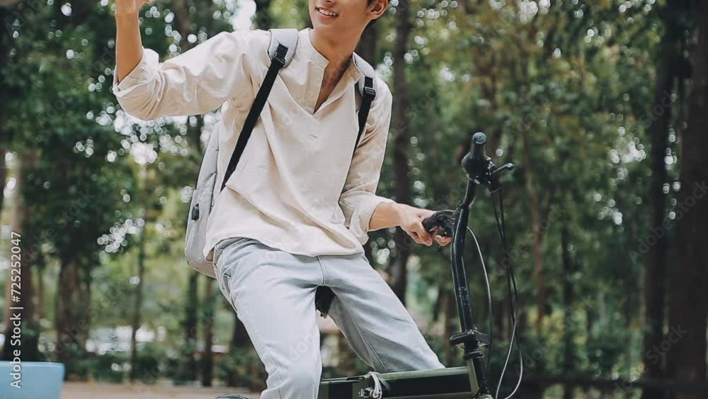 Man enjoying music using earphones while commuting to office on a bicycle. Businessman biking to office while listening to music. Man enjoying music using earphones while commuting to office on a bicycle. Businessman biking to office while listening to music.