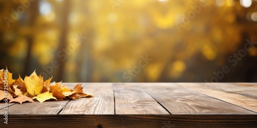 Autumn-themed wooden table with fall colors in the background.