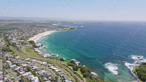 Stunning aerial drone flight over Kiama Downs, a coastal country town 120 kilometres south of Sydney, New South Wales, Australia. Cathedral Rocks, a basalt rock formation, in the foreground. photo