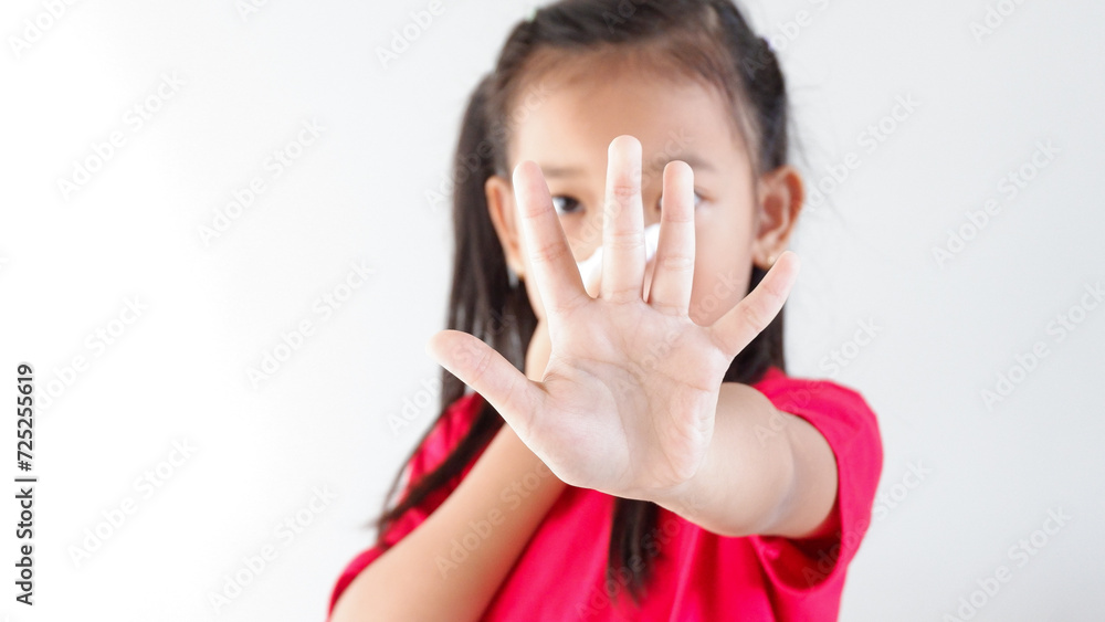 little Asian girl holding sick and sneeze with tissue paper. stop hands gesture for stop corona virus outbreak. little Asian girl holding sick and sneeze with tissue paper. stop hands gesture for stop corona virus outbreak.