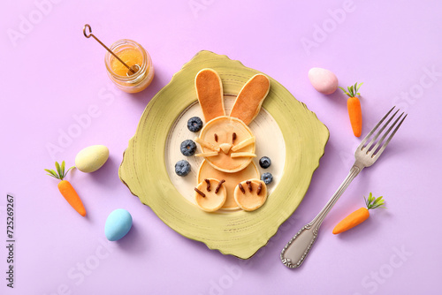 Funny Easter bunny pancakes with blueberry on lilac background