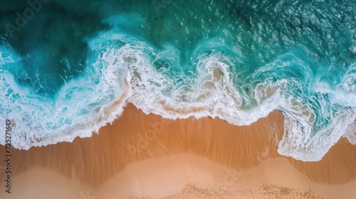  an aerial view of a beach with waves crashing on the sand and a sandy beach with a blue ocean in the background.